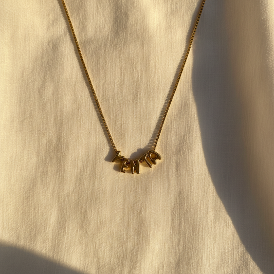 Gold Yenta Bubble letter necklace on box chain