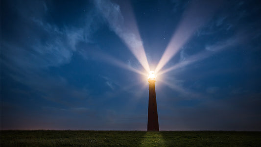 Lighthouse beacon shining in the dark