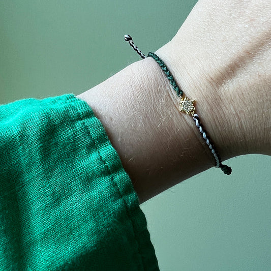 Jewish star friendship bracelet on wrist.