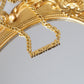 Product shot of gold mensch necklace on gold mirror.